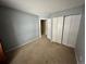 Empty bedroom with double door closet and carpeted floor at 17422 E Progress Dr, Centennial, CO 80015
