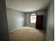 Simple bedroom with carpeted floor, window, and built-in shelving at 17422 E Progress Dr, Centennial, CO 80015
