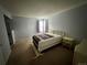 Bright bedroom with double bed, nightstand, and carpeted floor at 17422 E Progress Dr, Centennial, CO 80015