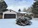 Ranch-style home with attached garage, snow-covered lawn, and mature shrubs at 17422 E Progress Dr, Centennial, CO 80015