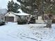 House exterior, snow-covered yard, and attached garage at 17422 E Progress Dr, Centennial, CO 80015