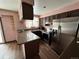 Galley kitchen with stainless steel appliances and dark brown cabinetry at 17422 E Progress Dr, Centennial, CO 80015