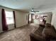 Living room with brown couch and view of the kitchen at 17422 E Progress Dr, Centennial, CO 80015