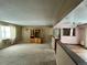 Spacious living room with wall-to-wall carpeting and a view into the kitchen at 17422 E Progress Dr, Centennial, CO 80015