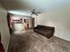 Living room with brown couch and view of kitchen at 17422 E Progress Dr, Centennial, CO 80015