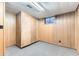 Basement storage area with gray carpet and paneled walls at 6051 Ivanhoe St, Commerce City, CO 80022