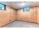 Finished basement area with paneled walls and carpeted floors at 6051 Ivanhoe St, Commerce City, CO 80022
