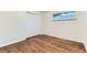 Bedroom with hardwood floors and closet at 6051 Ivanhoe St, Commerce City, CO 80022