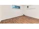 Clean bedroom with hardwood floors and bright natural light at 6051 Ivanhoe St, Commerce City, CO 80022