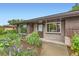 Inviting entrance with brick facade, large windows, and a beautifully landscaped garden at 6051 Ivanhoe St, Commerce City, CO 80022