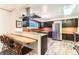 Updated kitchen featuring stainless steel appliances, a breakfast bar, and wood-look flooring at 6051 Ivanhoe St, Commerce City, CO 80022