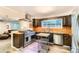 Gourmet kitchen featuring stainless steel appliances, custom cabinetry, and ample counter space at 6051 Ivanhoe St, Commerce City, CO 80022