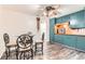 Kitchen nook featuring blue cabinets, wood countertops, and a dining table set at 6051 Ivanhoe St, Commerce City, CO 80022