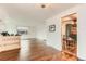 Spacious living room with hardwood floors, a decorative light fixture and a view into the Kitchen at 6051 Ivanhoe St, Commerce City, CO 80022