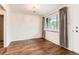 Living room with hardwood flooring, updated light fixture, and neutral colors at 6051 Ivanhoe St, Commerce City, CO 80022