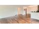Open living room with hardwood floors and neutral wall color at 6051 Ivanhoe St, Commerce City, CO 80022