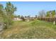 Expansive backyard featuring lush green grass, wooden fence, and storage shed at 8267 High St, Denver, CO 80229