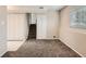 Finished basement space featuring a stairwell, neutral carpet, and built in closet space at 8267 High St, Denver, CO 80229