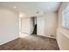 Finished basement space featuring a stairwell, neutral carpet, and built in closet space at 8267 High St, Denver, CO 80229