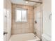 Shower-tub combo with neutral tile in the bathroom area at 8267 High St, Denver, CO 80229