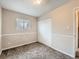 Neutral bedroom showcasing a double door closet, neutral carpet, trim work, and a sunny window at 8267 High St, Denver, CO 80229