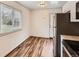 Bright kitchen with stainless steel appliances, plenty of counter space, and stylish wood-look flooring at 8267 High St, Denver, CO 80229