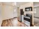 Efficient kitchen featuring modern stainless steel appliances, white cabinets, and bright lighting at 8267 High St, Denver, CO 80229