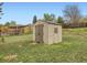 Outdoor storage shed with double doors and a window, set in backyard at 8267 High St, Denver, CO 80229