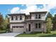 A modern two-story home boasts large windows and a neutral color palette, complemented by professional landscaping at 2645 Mondt Ln, Erie, CO 80026