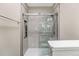 Modern bathroom featuring tiled shower with glass doors and built-in shelves at 7483 S Quail Cir # 626, Littleton, CO 80127