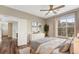 Cozy bedroom with hardwood floors, ceiling fan, large window and access to living area at 7483 S Quail Cir # 626, Littleton, CO 80127
