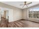 Bedroom showcasing wood floors, ceiling fan, and window with neighborhood views at 7483 S Quail Cir # 626, Littleton, CO 80127