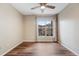 Bright, empty bedroom with a large window that lets in natural light and wood look flooring at 7483 S Quail Cir # 626, Littleton, CO 80127