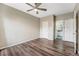 Bright bedroom featuring wood-look flooring and a ceiling fan, connecting to the bathroom at 7483 S Quail Cir # 626, Littleton, CO 80127