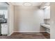 Dining area with hardwood floors, modern chandelier, and custom shelving unit at 7483 S Quail Cir # 626, Littleton, CO 80127