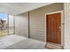 Condo front door with 'Welcome' mat, covered entry, and balcony view to the outside at 7483 S Quail Cir # 626, Littleton, CO 80127