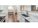 Galley kitchen features stainless steel appliances, granite countertops, and wood flooring at 7483 S Quail Cir # 626, Littleton, CO 80127