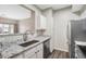 Updated kitchen featuring stainless appliances, granite counters, and modern grey tone flooring at 7483 S Quail Cir # 626, Littleton, CO 80127
