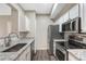 Well lit kitchen featuring stainless steel appliances, white cabinetry, and granite counters at 7483 S Quail Cir # 626, Littleton, CO 80127