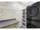 Efficient laundry room with washer/dryer, counter space and shelving at 7483 S Quail Cir # 626, Littleton, CO 80127