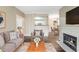 Cozy living room features fireplace and view into kitchen and dining areas at 7483 S Quail Cir # 626, Littleton, CO 80127
