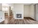 Living room featuring hardwood floors, a fireplace, and a glimpse into the kitchen area at 7483 S Quail Cir # 626, Littleton, CO 80127