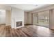 Open living room boasts fireplace, sliding door to patio, and hard surface floors at 7483 S Quail Cir # 626, Littleton, CO 80127