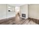 Cozy living room featuring hardwood floors, a fireplace, and a partial view of the kitchen at 7483 S Quail Cir # 626, Littleton, CO 80127