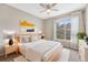 Comfortable bedroom with a large window, a ceiling fan, and an aesthetically pleasing bedside decor at 7483 S Quail Cir # 626, Littleton, CO 80127