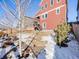 Yard with snow, trees, and a red house in the background at 4785 Basalt Ridge Cir, Castle Rock, CO 80108