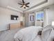 Spacious bedroom with a large bed, dresser and ceiling fan at 4785 Basalt Ridge Cir, Castle Rock, CO 80108