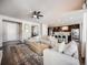 Open concept living room and kitchen with L-shaped sofa and large windows at 4785 Basalt Ridge Cir, Castle Rock, CO 80108