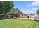 Expansive backyard featuring a covered patio, playhouse and shed at 7172 Kalamath St, Denver, CO 80221