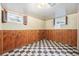 Basement featuring wood paneled walls and checkered floor at 7172 Kalamath St, Denver, CO 80221